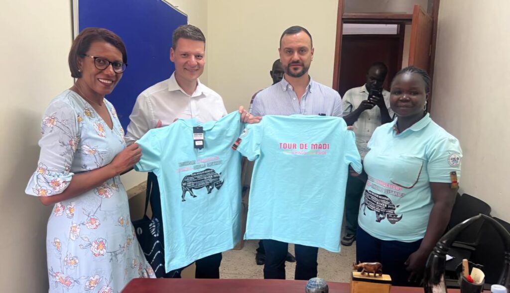 The founders of Race the Nile - Uganda Ultra Cycling Event from left; Lilly Ajarova, Klemens Kollenz and Pablo Rodriguez with representative of Ajai National Reserve, Uganda